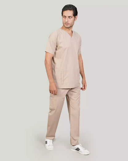 Full-body shot of a male medical professional in a complete beige Medfit men's scrub set, demonstrating comfort and a professional appearance for healthcare.