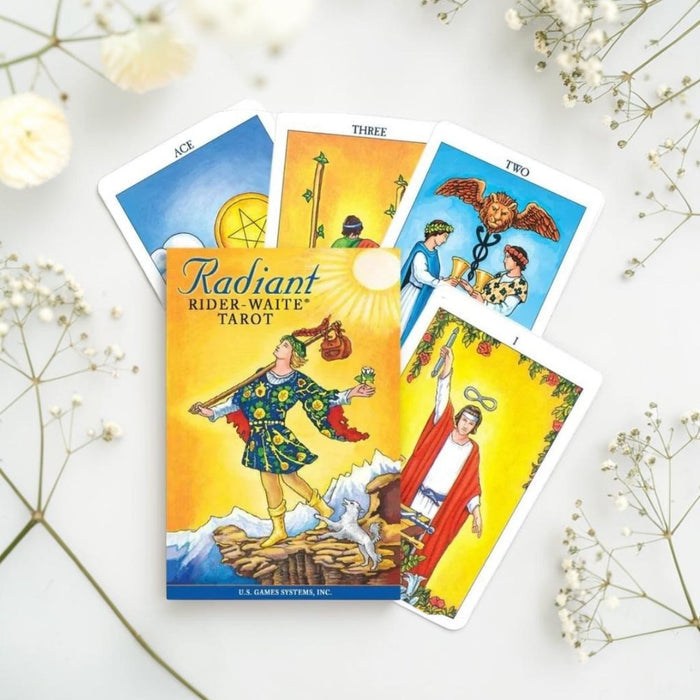 Radiant Rider-Waite Tarot book with tarot cards on a white background with flowers.
