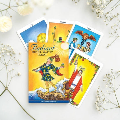 Radiant Rider-Waite Tarot book with tarot cards on a white background with flowers.