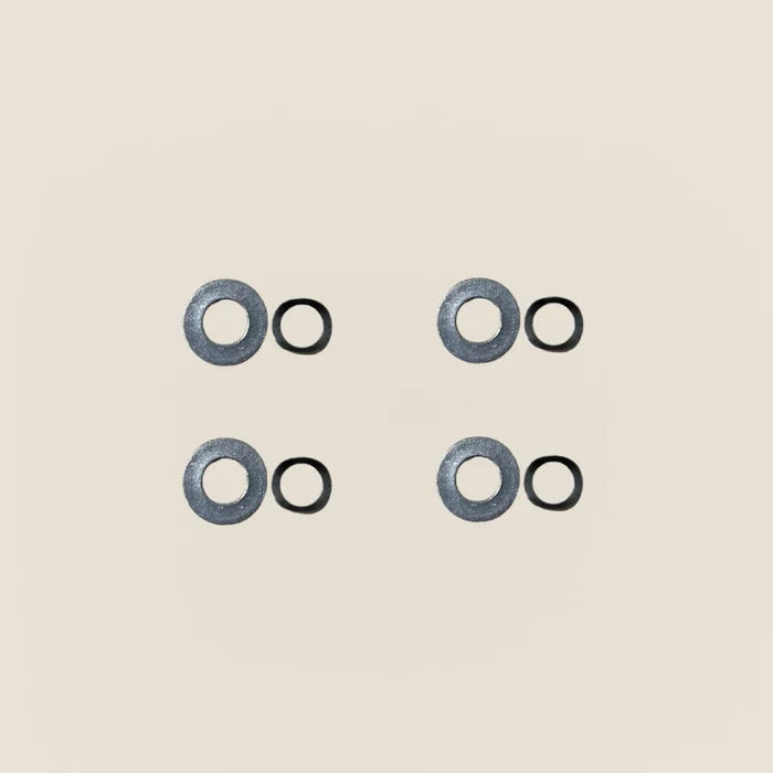 Four Gardner springs paired with four flat washers for Pilates Reformer guide wheels.