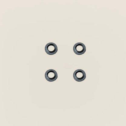 Four dark metal Gardner springs and flat washers for a Pilates reformer guide wheel.