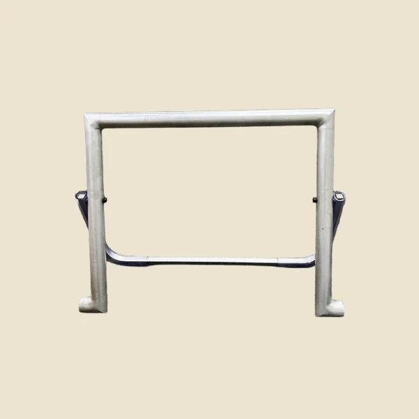 Metal foot bar unit with support bar for the Archive Pilates reformer, on beige background.