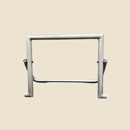 Metal foot bar unit with support bar for the Archive Pilates reformer, on beige background.