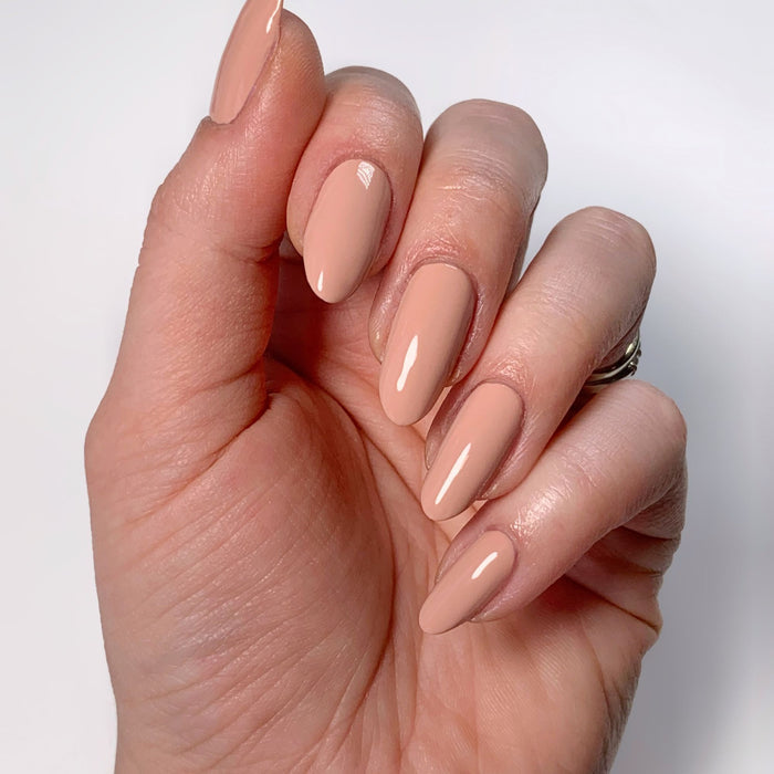 Glossy, pink beige "Rose Latte" nails by LONDONTOWN radiate warmth against a pristine white background.