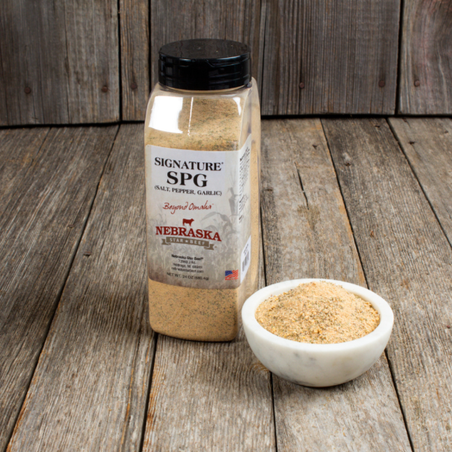 Nebraska Signature SPG seasoning bottle and bowl on wooden surface
