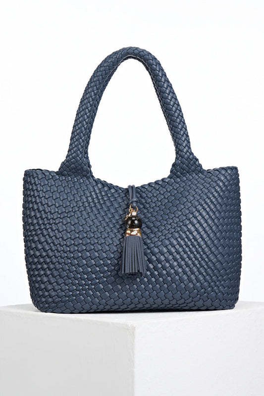 Front view of Saskia Denim Blue faux leather Woven Tote with Thames Tassel closure detail