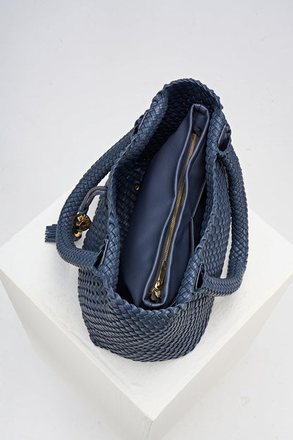 Overhead view of the inside of Saskia Denim Blue faux leather Woven Tote with internal detachable zipper pouch