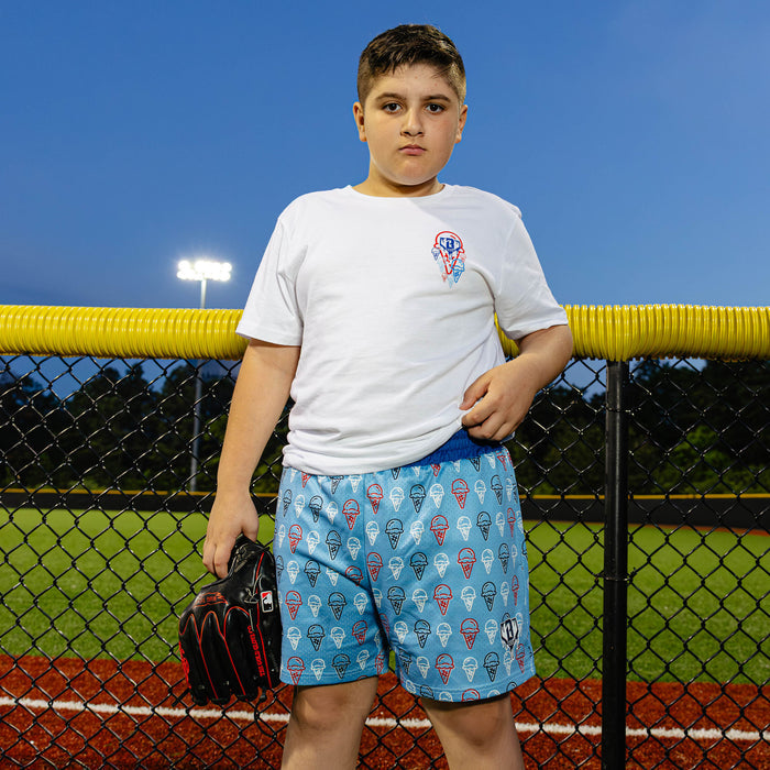 Youth model wearing red, white & blue Scoops Ice Cream Light Blue youth shorts
