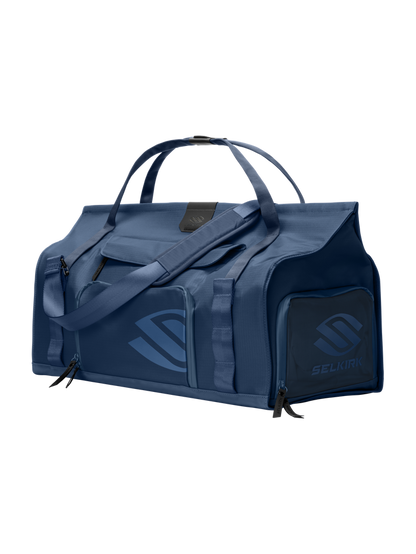 Front-right view of Selkirk Pro Line 2.0 duffel bag with top handles, padded shoulder strap and exterior zip pockets on dark background