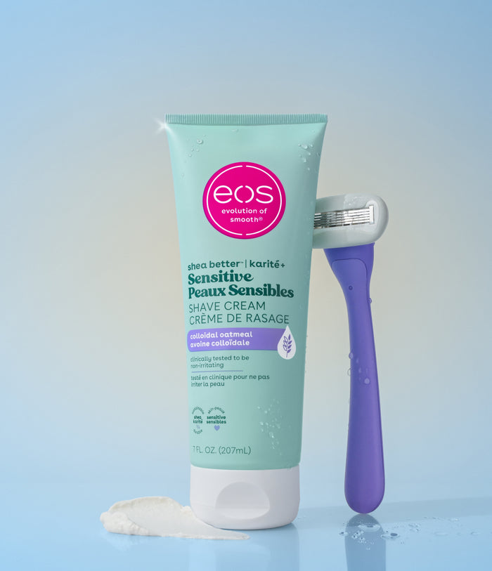 Eos Sensitive Peaux Sensibles shave cream with a purple razor on a gradient blue background