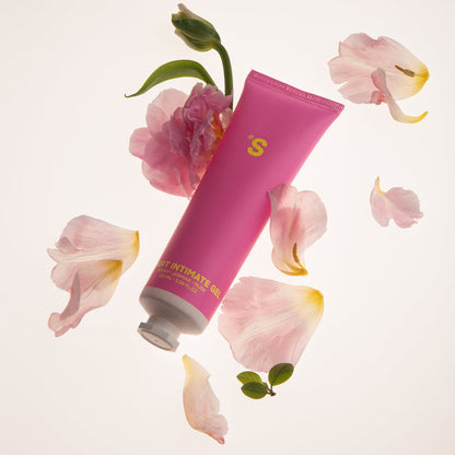 Pink tube of intimate wash with peony on a light pink background
