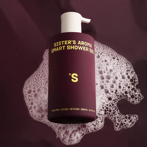 Bottle of Sister's Aroma Smart Shower Gel Fig with foam on a dark background