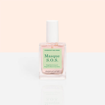 A clear glass bottle of Manucurist S.O.S. Nail Mask, a hydrating nail treatment with a white cap and light pink liquid, sits against a pastel peach and white background.