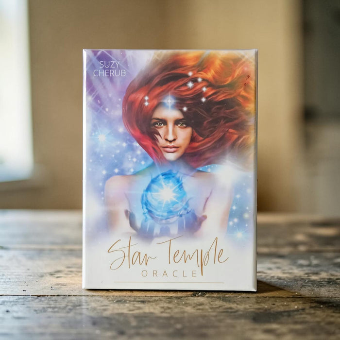 Deck titled 'Star Temple Oracle' by Suzy Cherub on a wooden surface with a blurred background