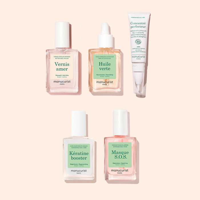 The Manucurist Ultimate Routine - Bitten Nails set, featuring Vernis Amer, Huile Verte, Concentré Perfeccteur, Kératine Booster, and Masque S.O.S., is elegantly arranged against a pale pink backdrop. Specially formulated to encourage nail regrowth and ideal for those with bitten nails, this collection supports healthy nail strengthening as part of your self-care routine.