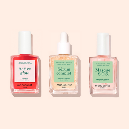 Three manicure products in glass dropper bottles are displayed side by side on a beige background: Basic Routine - Sensitive Nails from Manucurist, offering essential nail care solutions designed specifically for sensitive nails.