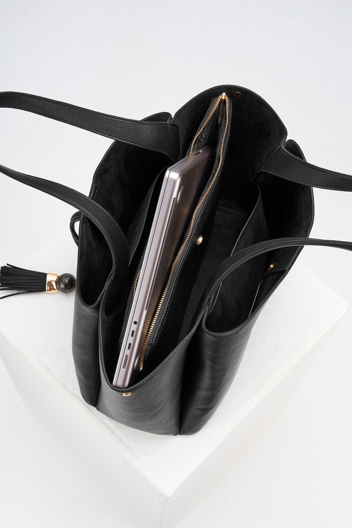 Overhead view of the inside of Stella Black faux leather Laptop Tote showing internal compartments and detachable central zipper laptop compartment