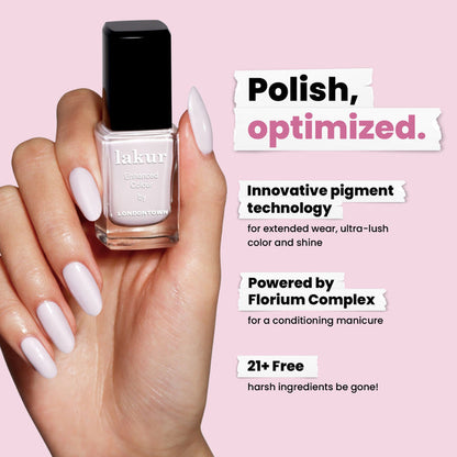 A hand with pastel purple nails holds a LONDONTOWN Strawberry Milk Lakur bottle; text highlights its milky pigment technology, conditioning formula, and that it's made without 21+ harsh ingredients.