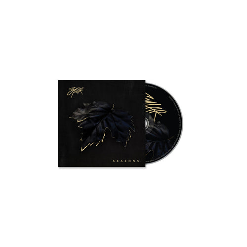 The Sylar CD and case have a black background with a dark, gold-outlined leaf in the center. SEASONS, inspired by tracks like Open Wounds, and Sylar’s stylized signature are displayed in shimmering gold lettering.