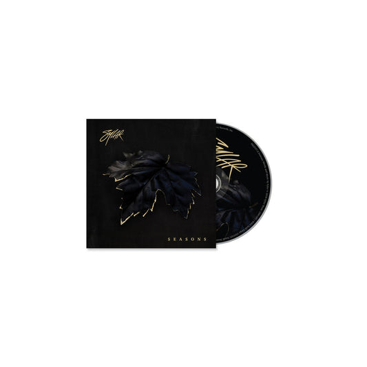 The Sylar CD and case have a black background with a dark, gold-outlined leaf in the center. SEASONS, inspired by tracks like Open Wounds, and Sylar’s stylized signature are displayed in shimmering gold lettering.
