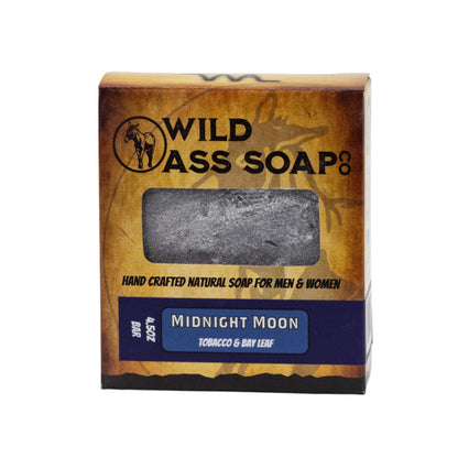 A packaged bar of soap labeled 'Wild Ass Soap Co. Midnight Moon' with a window showing the gray bar of soap inside.