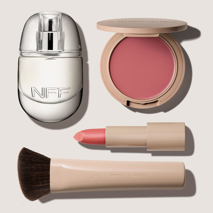 No Makeup Makeup – Makeup set with No Fragrance Fragrance, blush & lip color, Creme Classic Lipstick, and blush brush on a light background, natural minimal makeup