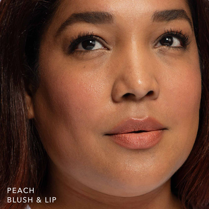 Tanned skin woman wearing Blush & Lip Color in Peach