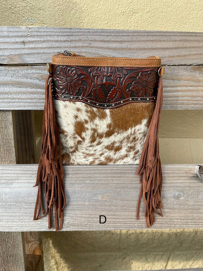 This Brown tooled leather and cowhide bag features side fringe. Front View D