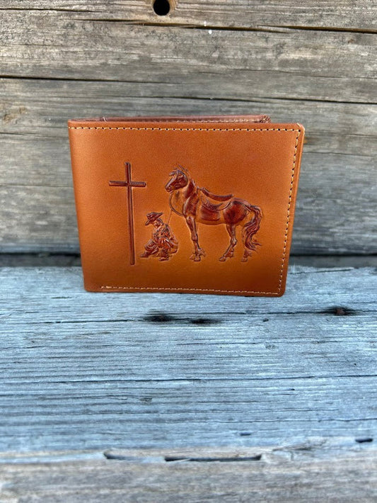 Light brown leather bifold wallet featuring a embossed Praying Cowboy design on the front. Front View