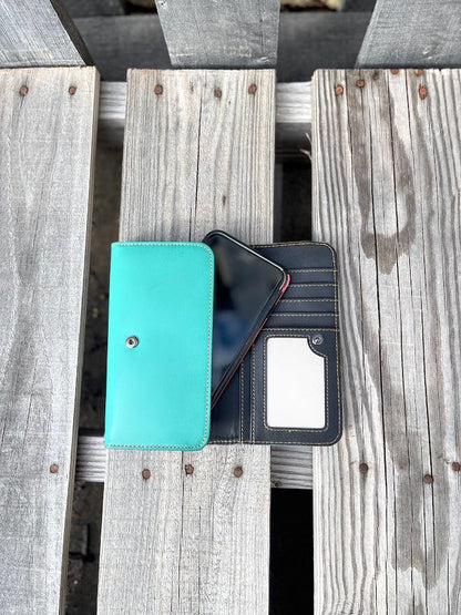 Turquoise Basketweave leather phone case wallet with wristlet strap. Inside view showing ID window, multiple card slots, and phone fitting in pouch.