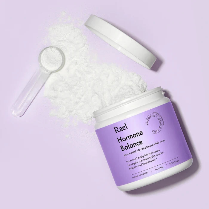 Rael Hormone Balance jar open with powered formula and scoop on light purple background.