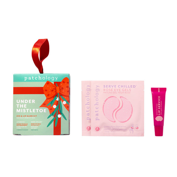 Under the Mistletoe eye and lip glow kit with a red ribbon hanger, shown with two rosé eye gel pouches and a pink gloss-to-balm lip treatment