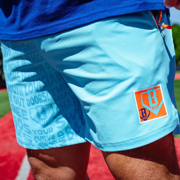 Adult model wearing blue shorts with "UVChangeup Trash Talk" design