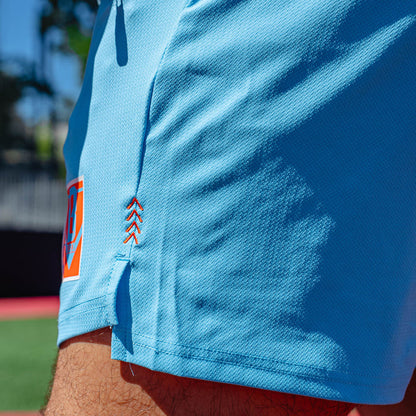 Adult model wearing blue shorts with "UVChangeup Trash Talk" design