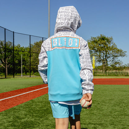 Youth model wearing multi-color youth hoodie with "UVChangeup Trash Talk Youth" design
