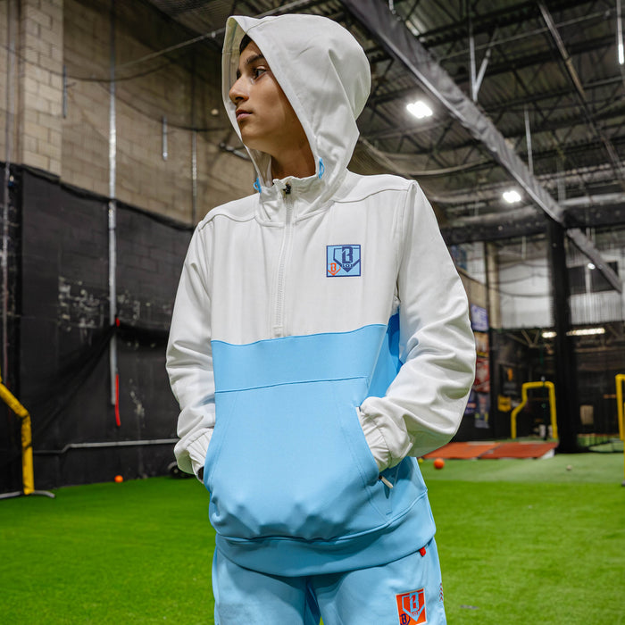Youth model wearing multi-color youth hoodie with "UVChangeup Trash Talk Youth" design
