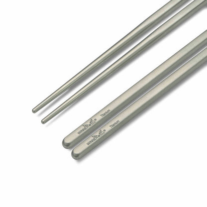 A close - up end - on view of Winnerwell® square titanium chopsticks, clearly showing the square cross - section of the chopsticks.