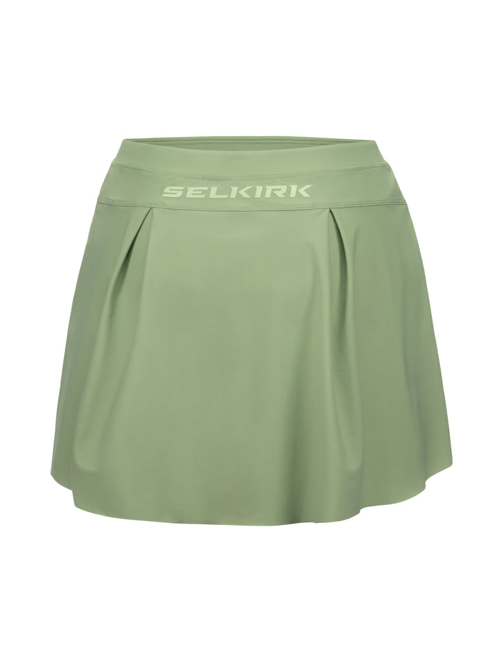 Sage-green athletic skort with pleated front and SELKIRK logo on the wide waistband