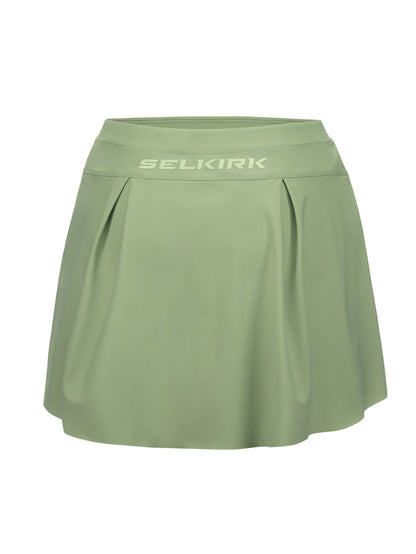 Sage-green athletic skort with pleated front and SELKIRK logo on the wide waistband