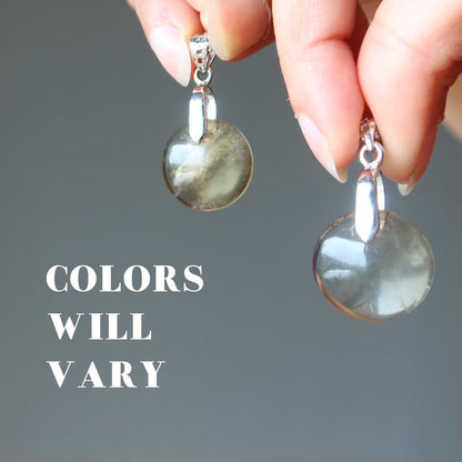 hand holding yellow quartz pendant