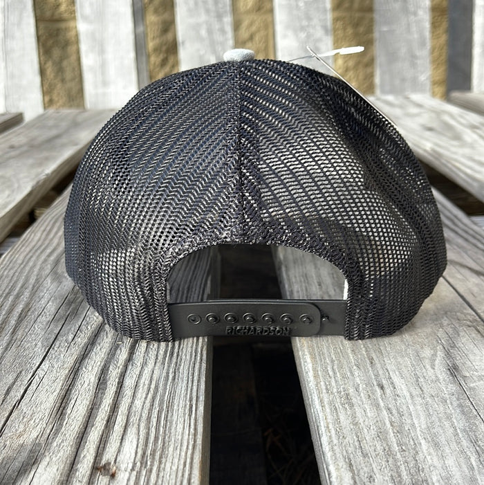 Side view of a youth-sized snapback cap with heather grey and black colors, featuring a leather patch logo on the front.
